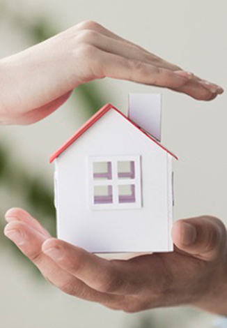 Hands holding house model